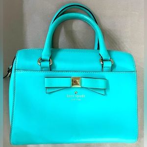 Kate Spade blue top handle bag with crossbody strap.